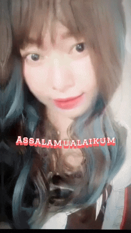 a close up of a woman 's face with the words assalamualaikum written in red