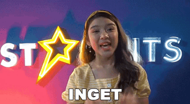 a young girl is standing in front of a neon sign that says inget