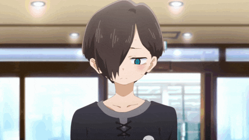 a girl with black hair and blue eyes is wearing a black shirt with a skull and crossbones on it