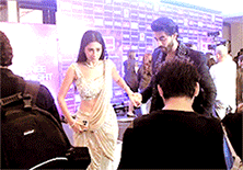 a man and a woman are dancing in front of a crowd of people