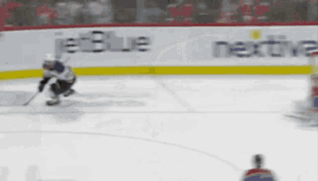 a hockey player on the ice with a jetblue advertisement in the background