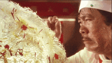 a man in a chef 's hat is looking at something