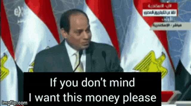 a man is giving a speech in front of flags and says if you don 't mind i want this money please ..