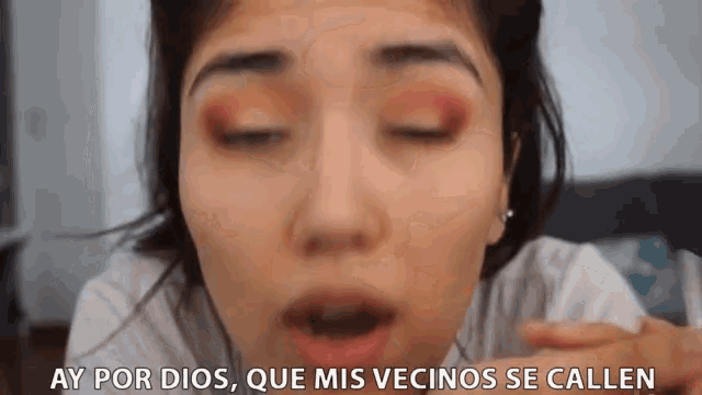 a close up of a woman 's face with ay por dios que mis vecinos se callen written below her