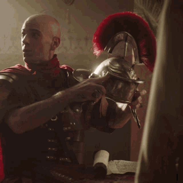 a bald man in a red cape and armor