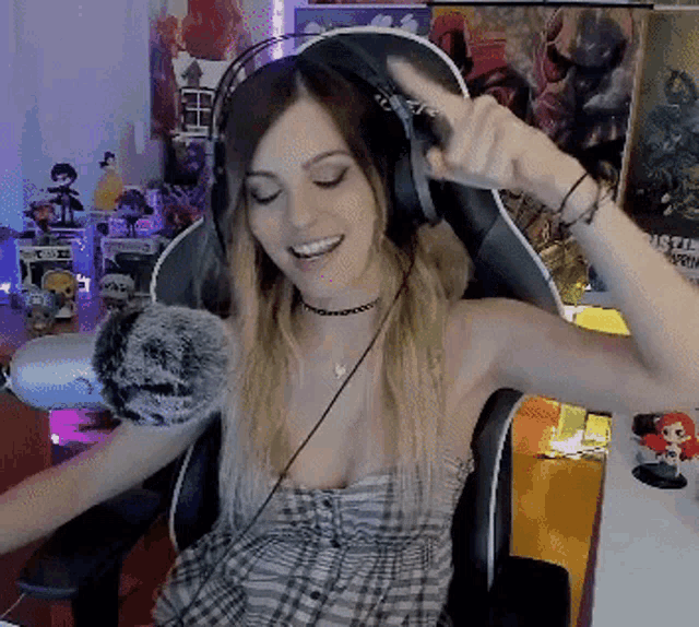 a woman wearing headphones sitting in a chair