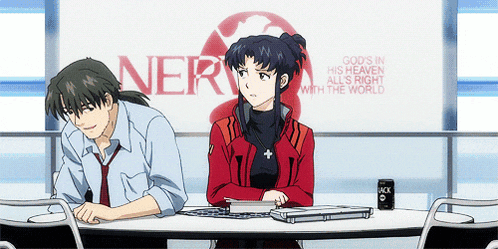 a man and woman sit at a table in front of a sign that says nerve