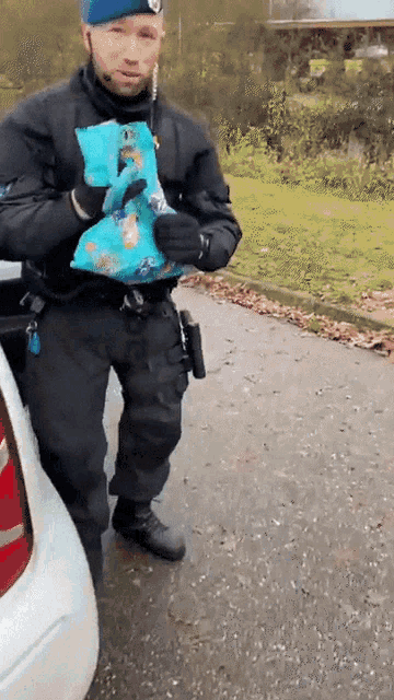 a police officer is holding a bag of food