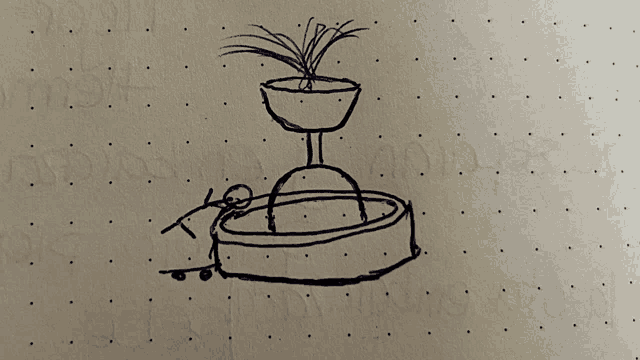 a drawing of a fountain with a plant in it is on a piece of paper