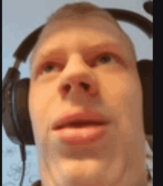 a close up of a man wearing headphones .