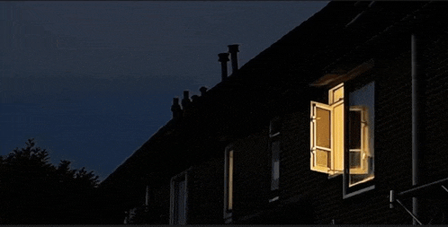 a dark house with a window that is open
