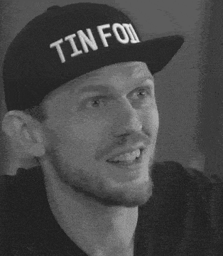 a man wearing a hat that says tinfoil