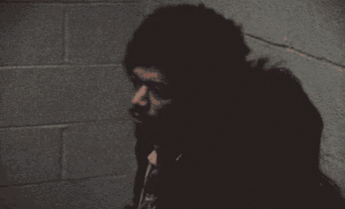 a person 's shadow is cast on a wall in a dark room