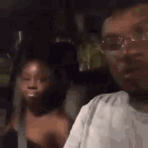a man and a woman are sitting in a car .