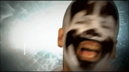 a blurry image of a man 's face with a beard