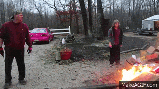 a man and a girl standing in front of a fire with makeagif.com at the bottom of the screen