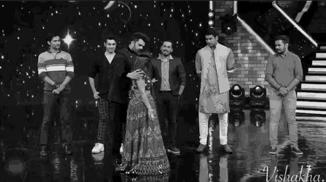 a black and white photo of a group of people with the name vishakha on the bottom left