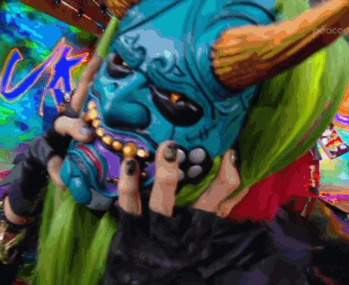 a person wearing a blue mask with horns and a green cape