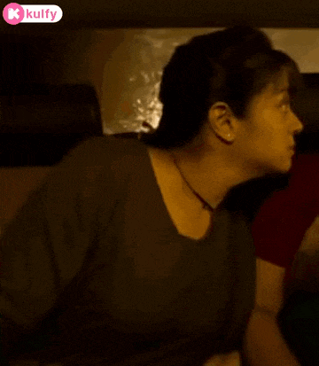 a woman is sitting in the back seat of a car with a man .
