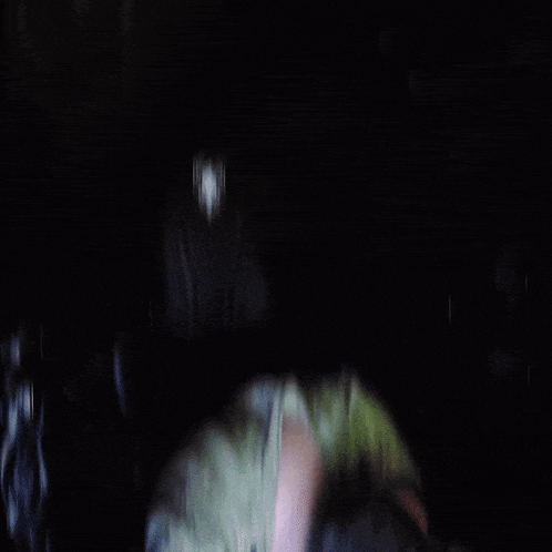 a person 's hand is visible in the dark