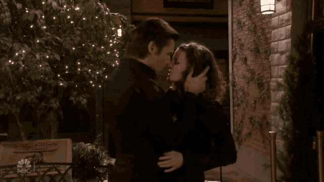 a man and a woman holding hands in front of a sign that says salem inn