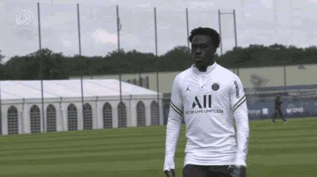 a soccer player wearing a white shirt that says all on it