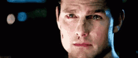 a close up of a man 's face with a tear running down his cheek .