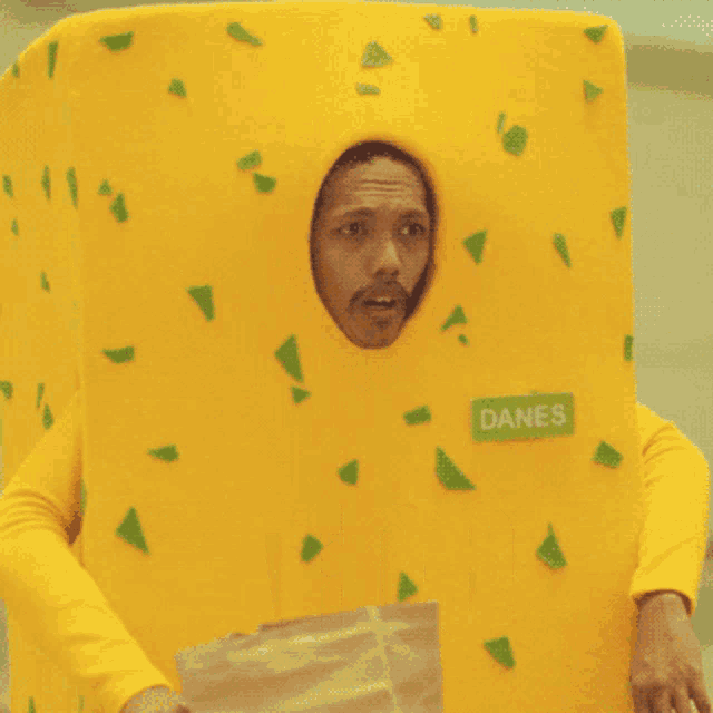 a man dressed as a piece of cheese with the word hatdog on the bottom