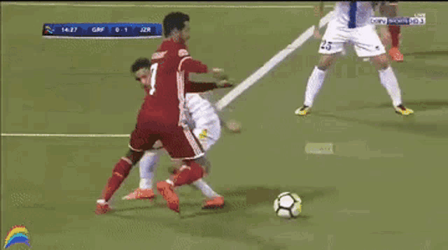 a soccer player with the number 7 on his jersey is being tackled
