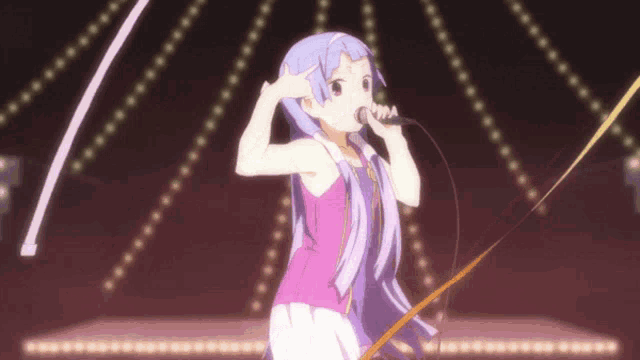 a girl with purple hair is singing into a microphone on a stage