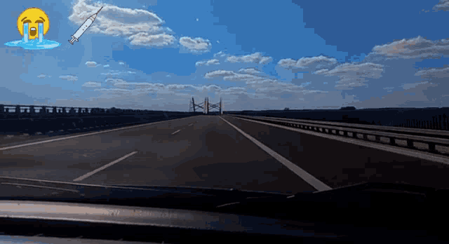 an empty highway with a crying face and a rocket in the background