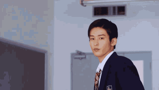a young man in a school uniform has a badge on his jacket that says ' aoyama '