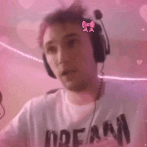 a man wearing headphones and a bow on his head .
