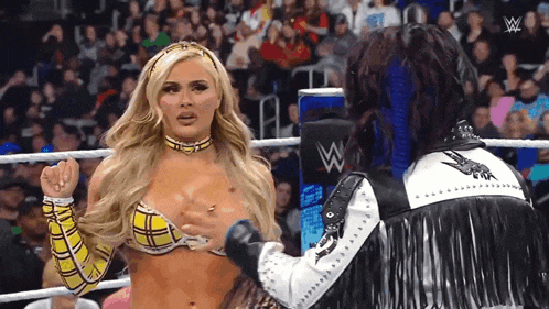 a woman in a plaid bikini is being touched by a man in a fringed jacket .