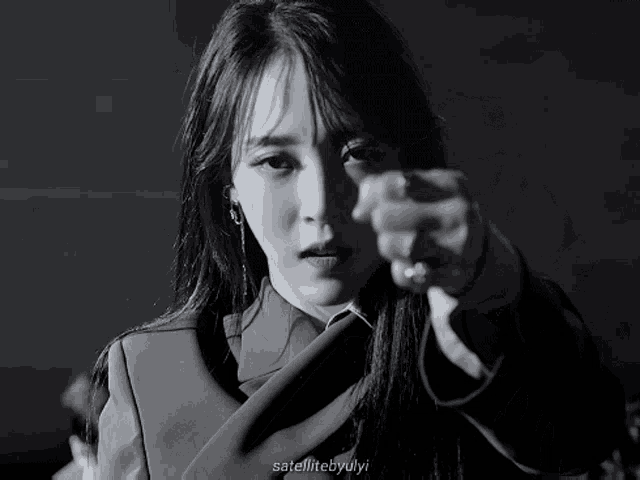 a black and white photo of a woman pointing with the caption satellitebyulyi