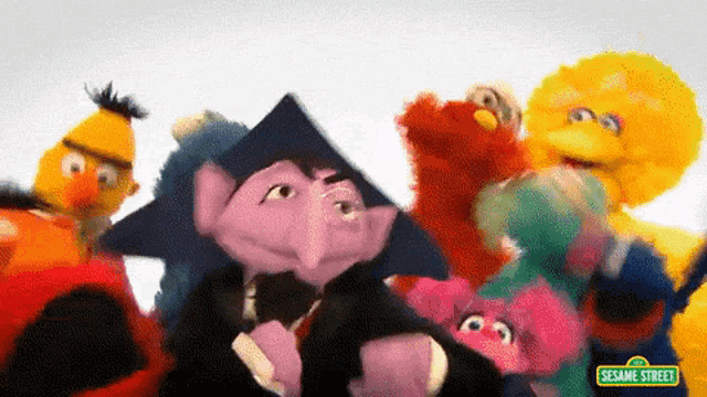 a group of sesame street characters are posing for a photo