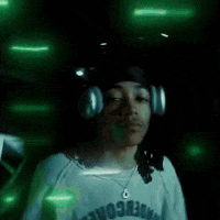 a blurry picture of a woman in a white hat dancing in the dark .