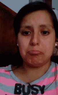 a woman wearing a pink striped shirt that says busy