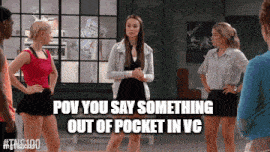 a group of women are standing in a room and one of them is saying something out of pocket in vc