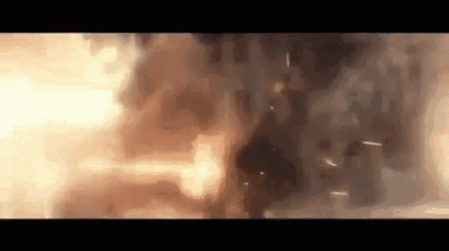 a large explosion is taking place in a dark room .