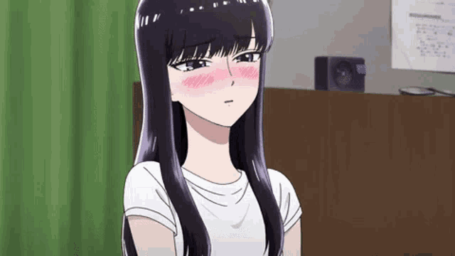 a girl with long black hair and a white shirt is sitting in a room with her eyes closed .