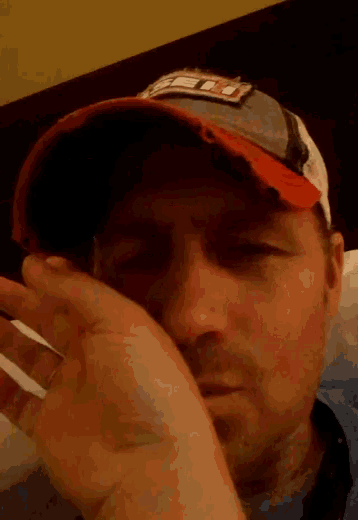 a man wearing a hat with a patch on it that says ' ed '