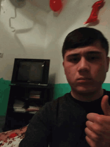 a young man is taking a selfie in front of a tv