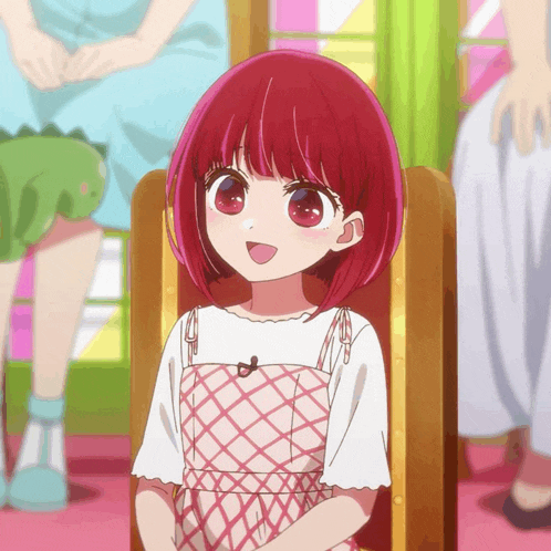 a girl with red hair sits in a chair