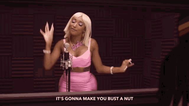 a woman singing into a microphone with the words " it 's gonna make you bust a nut " above her