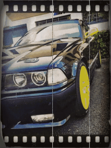a black car with yellow wheels is shown in a film strip