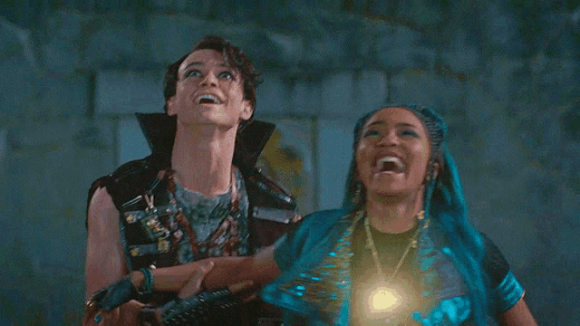 a man and a woman are standing next to each other and looking up