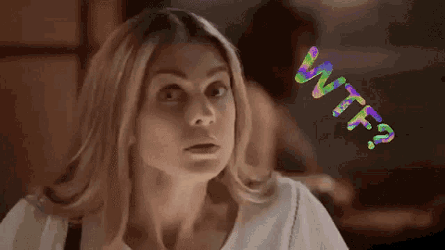 a woman is making a funny face with the words wtf ? behind her
