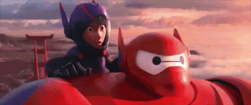 a boy and a robot are sitting next to each other in a car .