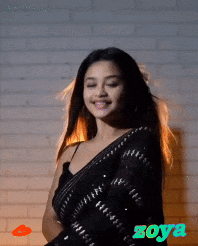 a woman in a black saree with the name zoya written on the bottom